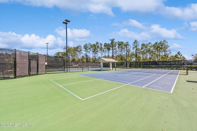 view of sport court featuring fence