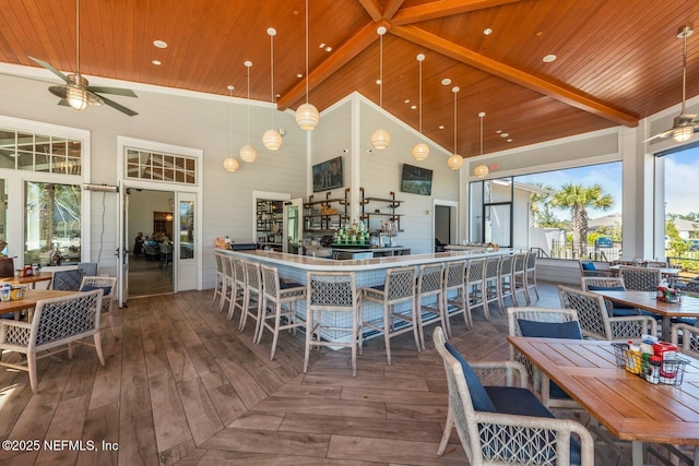 kitchen featuring ceiling fan, hardwood / wood-style flooring, recessed lighting, a high ceiling, and wood ceiling