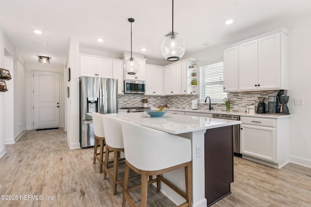 kitchen with open shelves, light wood-type flooring, white cabinetry, and stainless steel appliances