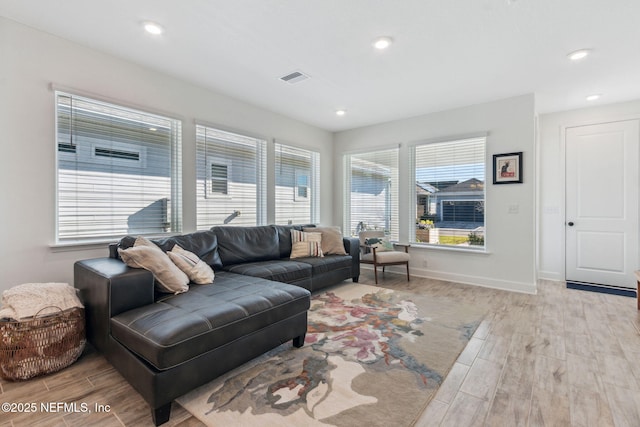 living room with wood finish floors, visible vents, baseboards, and recessed lighting