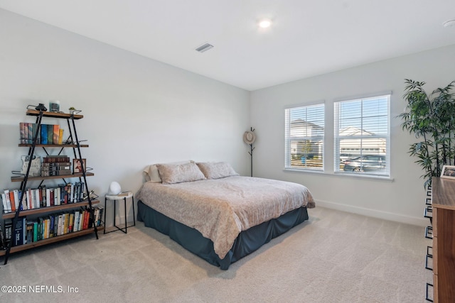 carpeted bedroom featuring visible vents and baseboards