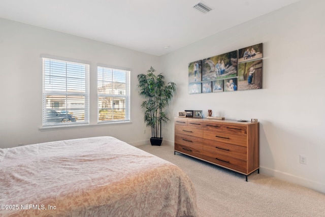 bedroom featuring light colored carpet, visible vents, and baseboards