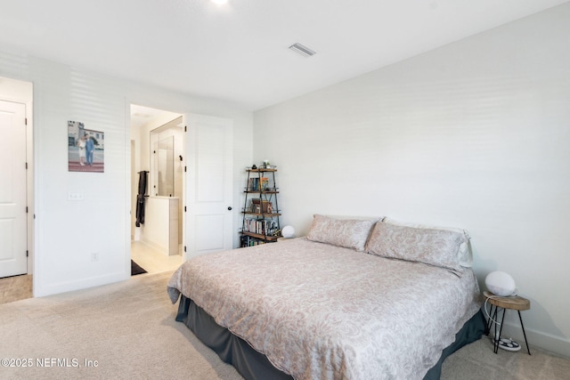 carpeted bedroom with visible vents and baseboards