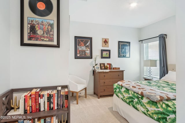 bedroom with light carpet and baseboards