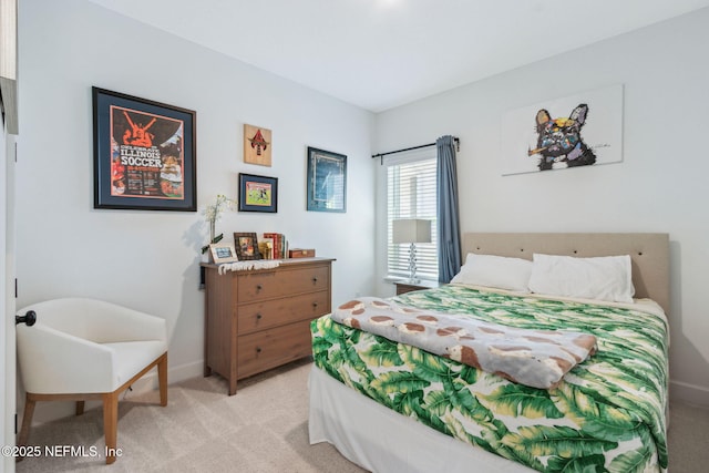 bedroom with light carpet and baseboards