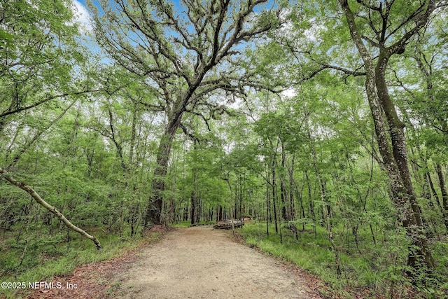 surrounding community featuring a wooded view