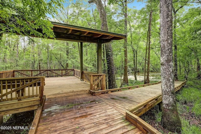 wooden deck featuring a view of trees