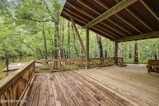 wooden deck with a wooded view