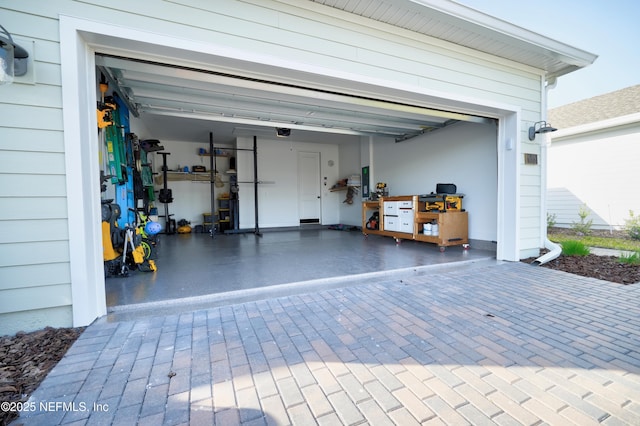 garage with decorative driveway