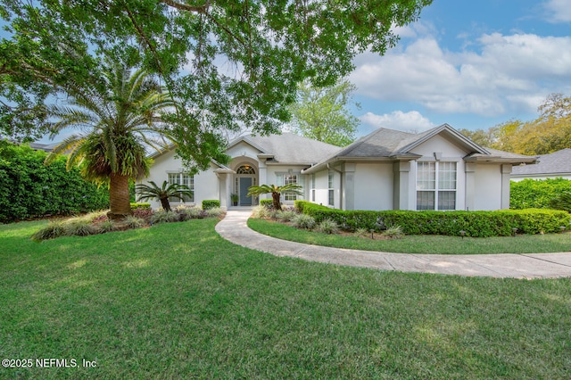 ranch-style house featuring stucco siding and a front lawn