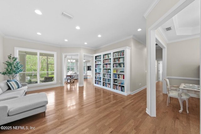 living area featuring light wood-type flooring, recessed lighting, crown molding, and visible vents