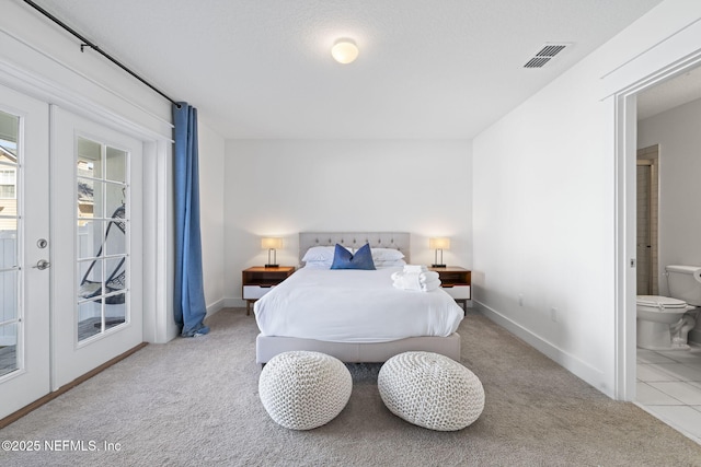 2072 Gail Ave, Jacksonville Beach, FL 32250 - carpeted bedroom with access to exterior, visible vents, connected bathroom, baseboards, and french doors