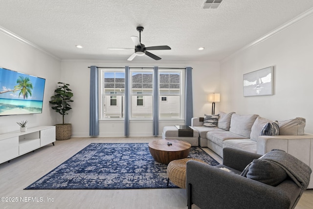 2072 Gail Ave, Jacksonville Beach, FL 32250 - living room featuring visible vents, crown molding, ceiling fan, wood finished floors, and a textured ceiling