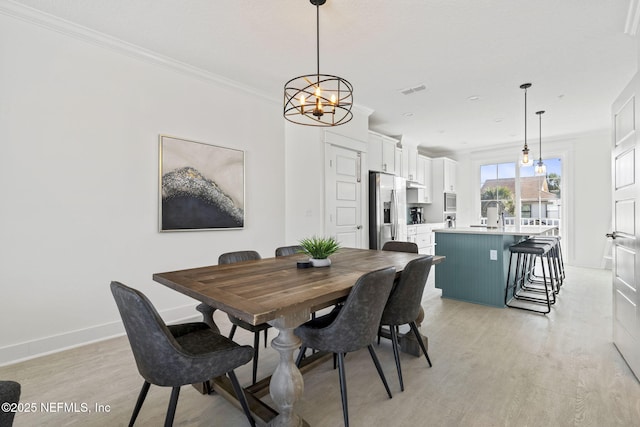 2072 Gail Ave, Jacksonville Beach, FL 32250 - dining area with visible vents, light wood-style flooring, baseboards, and ornamental molding