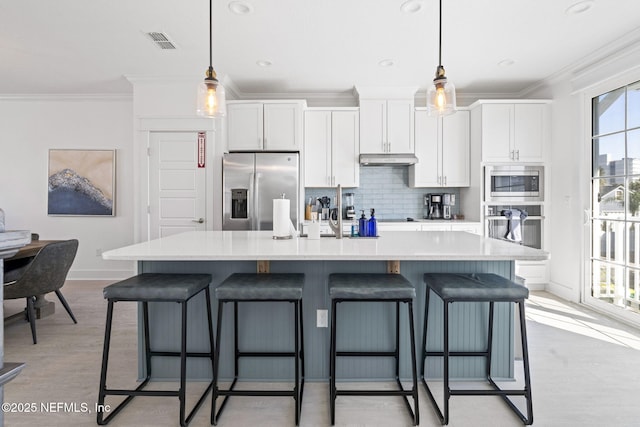 2072 Gail Ave, Jacksonville Beach, FL 32250 - kitchen with visible vents, a center island with sink, under cabinet range hood, white cabinetry, and appliances with stainless steel finishes