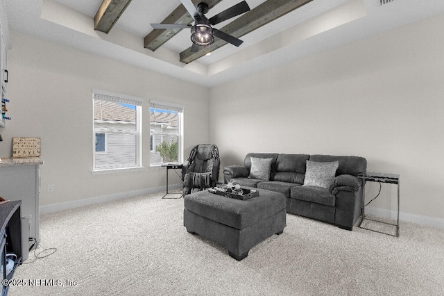 living room with a ceiling fan, beam ceiling, carpet floors, and baseboards