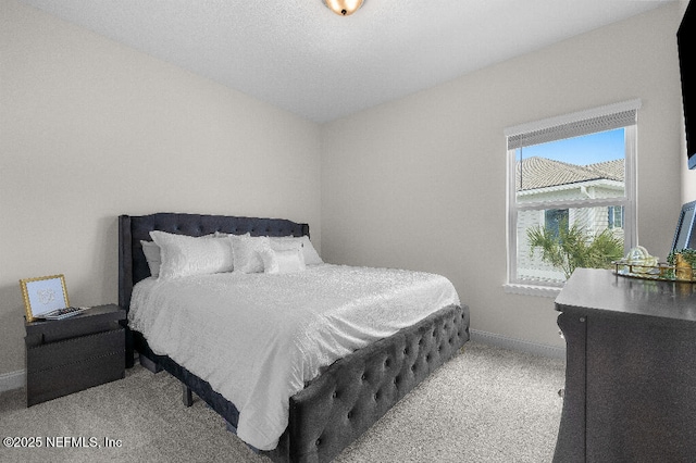 carpeted bedroom featuring baseboards