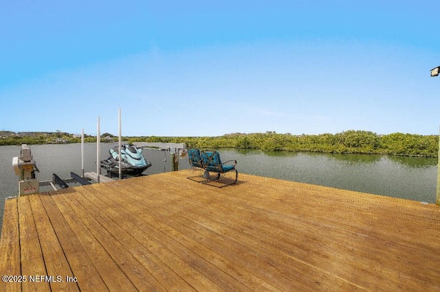 dock area with a water view and boat lift