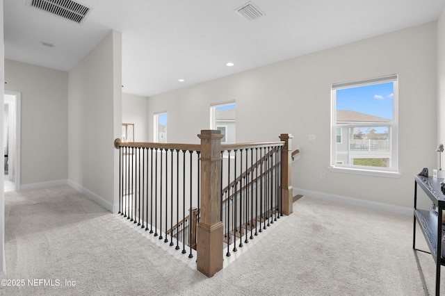 367 Five Island Dr, Saint Augustine, FL 32080 - hall with visible vents, an upstairs landing, plenty of natural light, and carpet