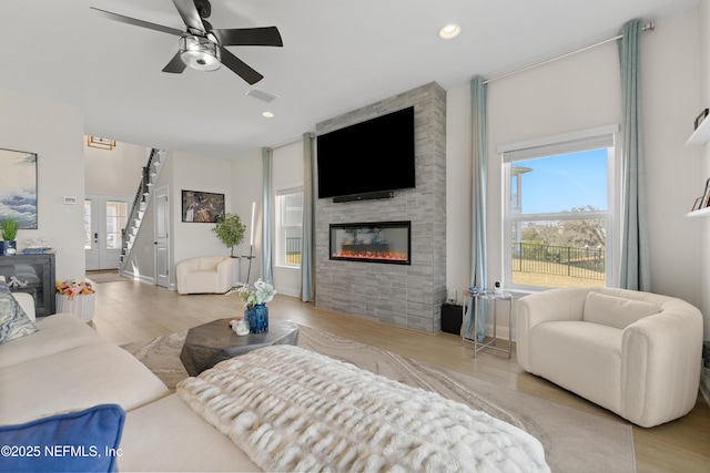 367 Five Island Dr, Saint Augustine, FL 32080 - living room with recessed lighting, wood finished floors, a tile fireplace, and a ceiling fan
