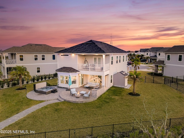 367 Five Island Dr, Saint Augustine, FL 32080 - back of property with a balcony, a patio area, a fenced backyard, an outdoor fire pit, and a lawn