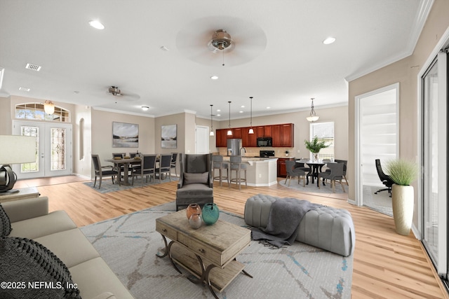 244 Palazzo Cir, Saint Augustine, FL 32092 - living room with crown molding, ceiling fan, light wood-type flooring, and recessed lighting