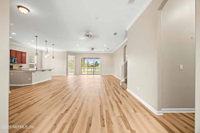 244 Palazzo Cir, Saint Augustine, FL 32092 - unfurnished living room with crown molding, light wood-style floors, plenty of natural light, baseboards, and recessed lighting