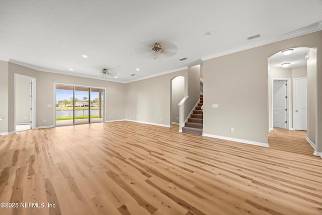 244 Palazzo Cir, Saint Augustine, FL 32092 - unfurnished living room featuring arched walkways, ornamental molding, baseboards, light wood finished floors, and a ceiling fan