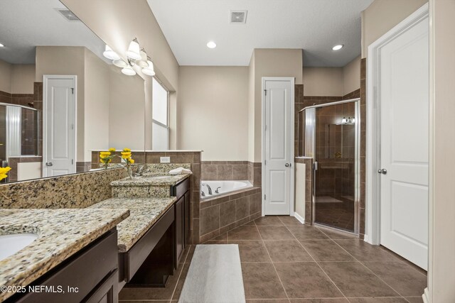 244 Palazzo Cir, Saint Augustine, FL 32092 - bathroom featuring vanity, a shower stall, a garden tub, and tile patterned floors
