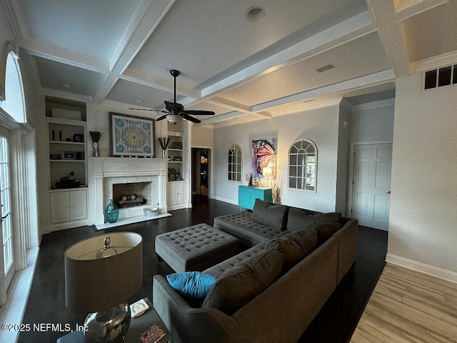 living area featuring wood finished floors, visible vents, coffered ceiling, baseboards, and a fireplace