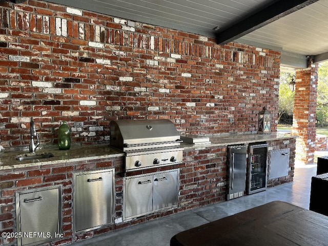 view of patio featuring a sink, a grill, and exterior kitchen