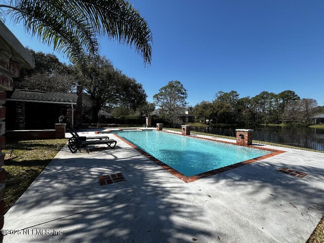 view of swimming pool featuring a fenced backyard, a fenced in pool, and a patio