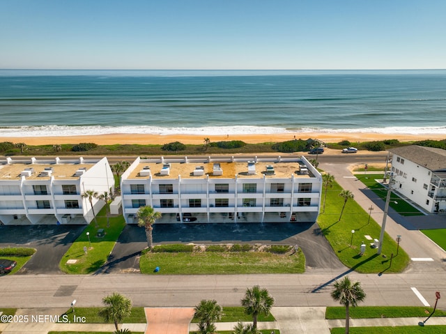 drone / aerial view with a beach view and a water view