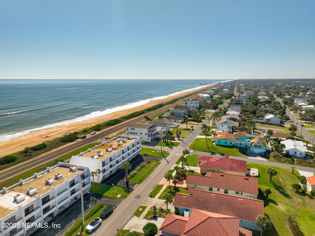 drone / aerial view with a water view and a view of the beach