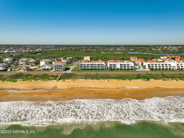 drone / aerial view featuring a view of the beach and a water view