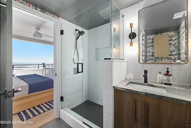 bathroom featuring visible vents, backsplash, connected bathroom, a shower stall, and vanity