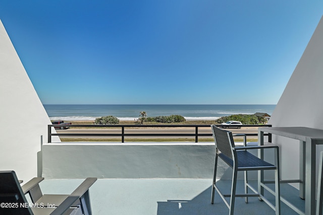 balcony with a view of the beach and a water view