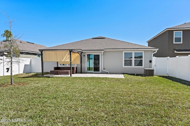 back of property featuring a yard, a patio, a fenced backyard, and a shingled roof