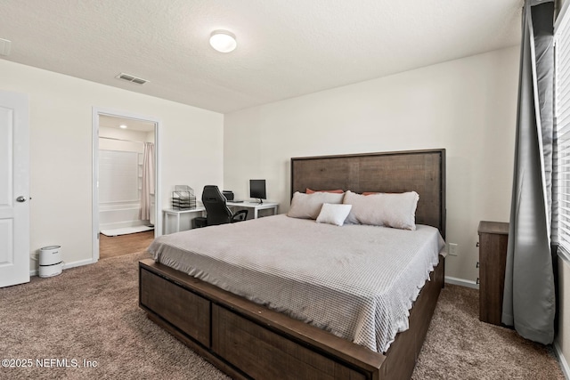 carpeted bedroom with visible vents, baseboards, a textured ceiling, and connected bathroom