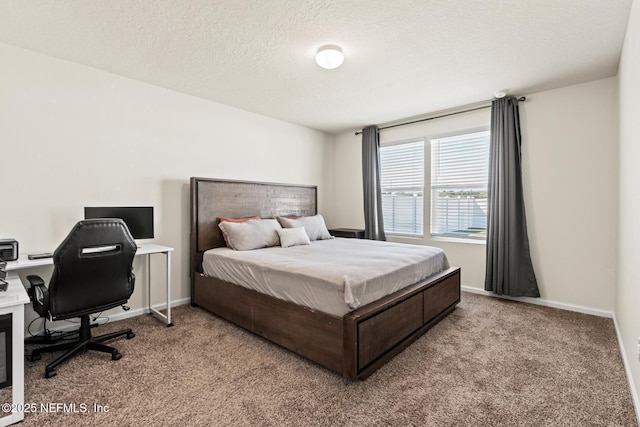 carpeted bedroom with a textured ceiling and baseboards