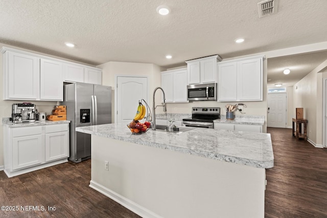 kitchen featuring dark wood-style flooring, appliances with stainless steel finishes, light countertops, and a sink