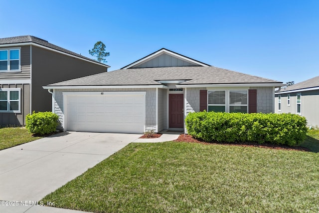 view of front of home with board and batten siding, concrete driveway, a front yard, roof with shingles, and an attached garage