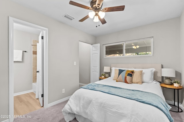 carpeted bedroom featuring baseboards, visible vents, and a ceiling fan