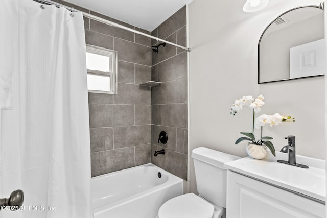 bathroom with shower / bath combo, visible vents, vanity, and toilet