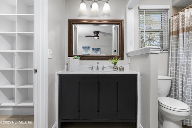 full bathroom featuring ceiling fan, built in features, toilet, tile patterned floors, and vanity