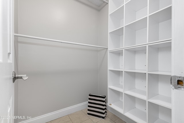 walk in closet with tile patterned flooring