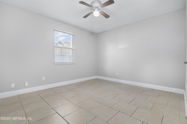 empty room with baseboards, a textured ceiling, and a ceiling fan