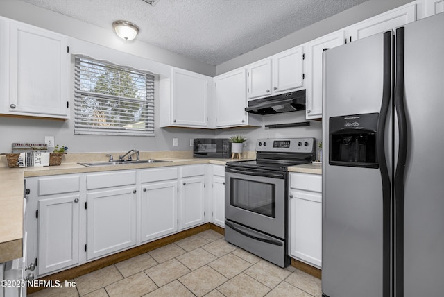 kitchen featuring under cabinet range hood, appliances with stainless steel finishes, light countertops, and a sink