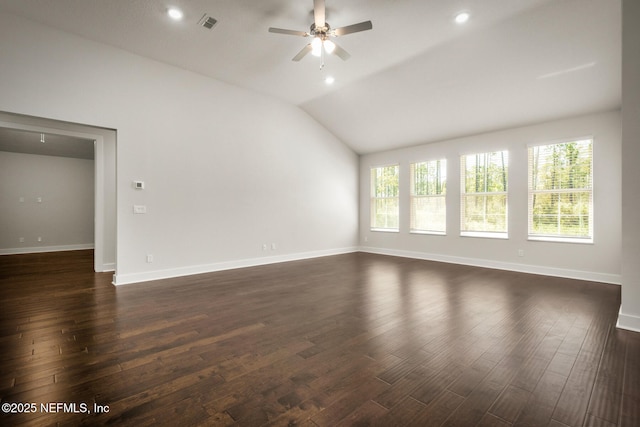 empty room with lofted ceiling, baseboards, a ceiling fan, and dark wood-style flooring