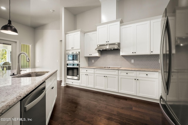 kitchen featuring under cabinet range hood, dark wood-style flooring, a sink, white cabinetry, and appliances with stainless steel finishes